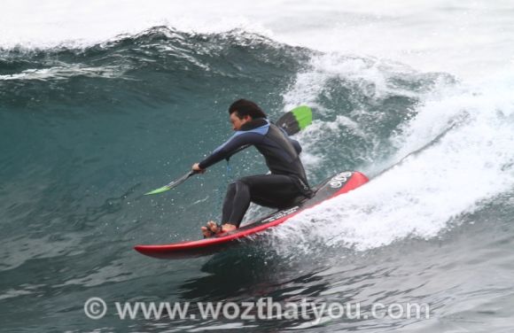 Nasty high brace as he drops in on the wave (Image Credit: www.wozthatyou.com )