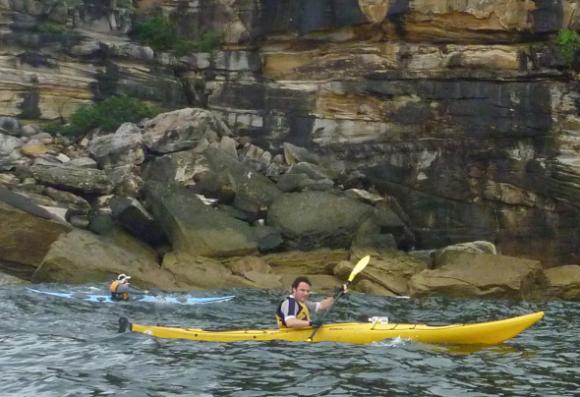 Sacha paddling past Middle Head (with Timbo in the background)