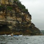 Timbo paddling along the cliff at Middle Head