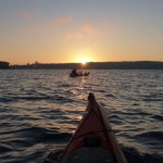 The rising sun and a lone kayak fisherman