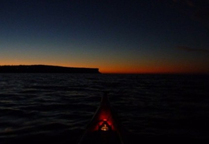 Paddling out to sea in the darkness