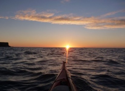 Sunrise over calm seas.