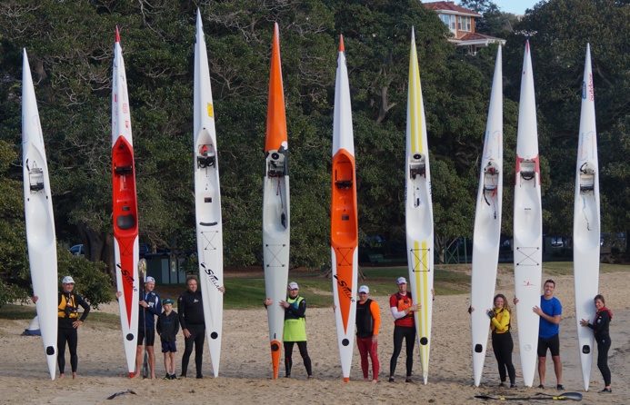 Blast paddlers pose for the stern to nose surfski shot